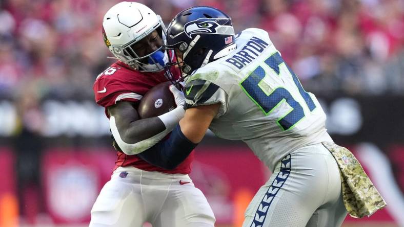 Nov 6, 2022; Glendale, Arizona, USA; Seattle Seahawks linebacker Cody Barton (57) tackles Arizona Cardinals running back Eno Benjamin (26) during the second half at State Farm Stadium. Mandatory Credit: Joe Camporeale-USA TODAY Sports