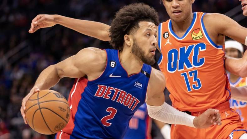 Nov 7, 2022; Detroit, Michigan, USA; Oklahoma City Thunder forward Ousmane Dieng (13) defends against Detroit Pistons guard Cade Cunningham (2) during the second half at Little Caesars Arena. Mandatory Credit: David Reginek-USA TODAY Sports