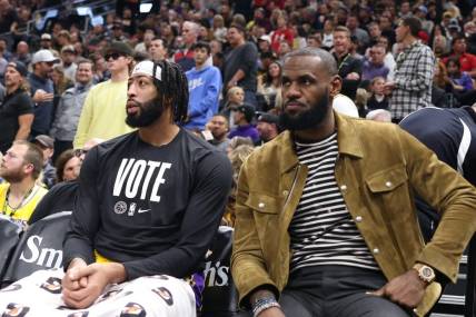 Nov 7, 2022; Salt Lake City, Utah, USA; Los Angeles Lakers forward Anthony Davis (left) and forward LeBron James (right) watch from the bench as their team play the Utah Jazz in the second half at Vivint Arena. Mandatory Credit: Rob Gray-USA TODAY Sports