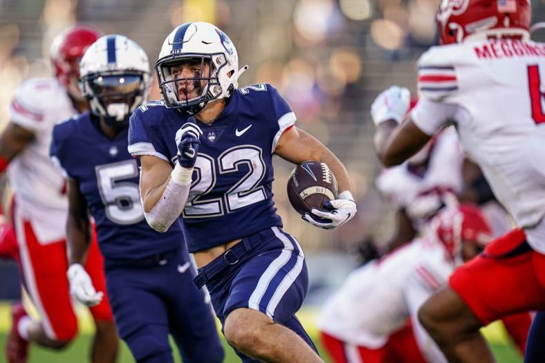 Nov 12, 2022; East Hartford, Connecticut, USA; Connecticut Huskies running back Victor Rosa (22) runs the ball for a touchdown against the Liberty Flames in the second half at Rentschler Field at Pratt & Whitney Stadium. Mandatory Credit: David Butler II-USA TODAY Sports
