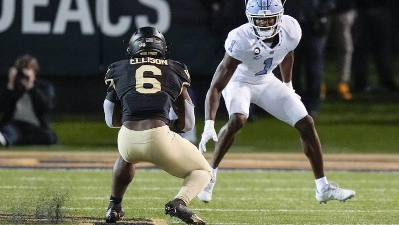 Nov 12, 2022; Winston-Salem, North Carolina, USA;  Wake Forest Demon Deacons running back Justice Ellison (6) tries to evade North Carolina Tar Heels defensive back Tony Grimes (1) during the second half at Truist Field. Mandatory Credit: Jim Dedmon-USA TODAY Sports