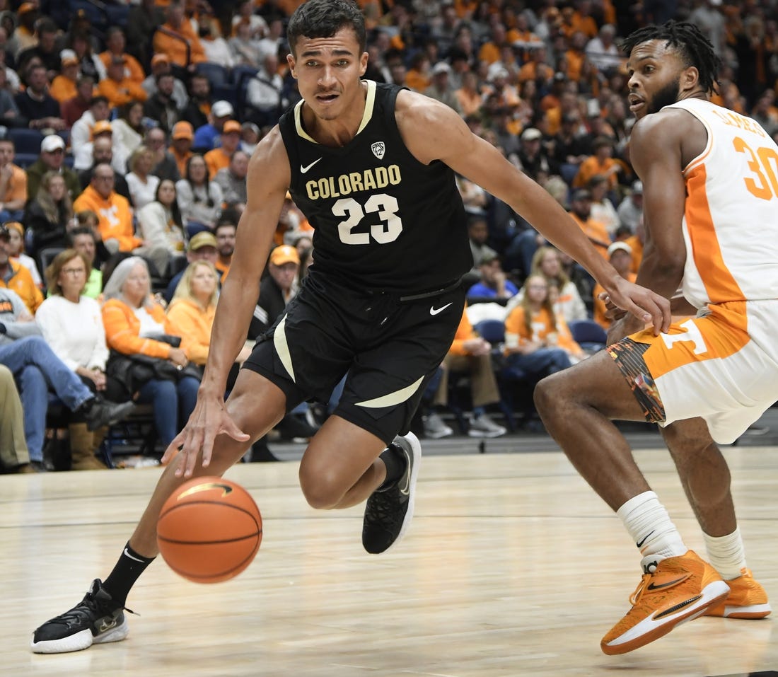 Nov 13, 2022; Nashville, Tennessee, USA;  Colorado Buffaloes forward Tristan da Silva (23) dribbles past Tennessee Volunteers guard Josiah-Jordan James (30) during the second half at Bridgestone Arena. Mandatory Credit: Steve Roberts-USA TODAY Sports