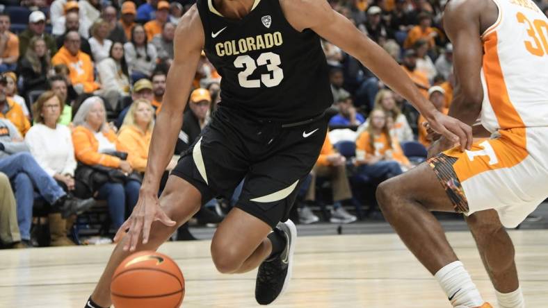 Nov 13, 2022; Nashville, Tennessee, USA;  Colorado Buffaloes forward Tristan da Silva (23) dribbles past Tennessee Volunteers guard Josiah-Jordan James (30) during the second half at Bridgestone Arena. Mandatory Credit: Steve Roberts-USA TODAY Sports