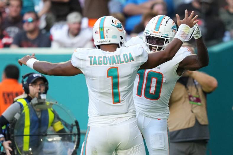 Nov 13, 2022; Miami Gardens, Florida, USA; Miami Dolphins wide receiver Tyreek Hill (10) celebrates the touchdown of running back quarterback Tua Tagovailoa (1)  during the second half at Hard Rock Stadium. Mandatory Credit: Jasen Vinlove-USA TODAY Sports