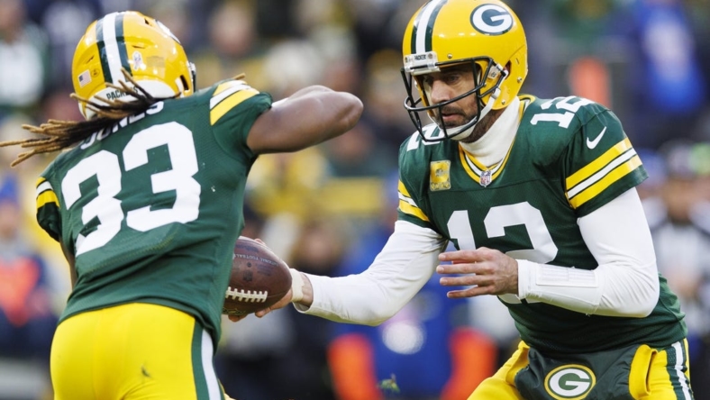 Nov 13, 2022; Green Bay, Wisconsin, USA;  Green Bay Packers quarterback Aaron Rodgers (12) hands the ball off to Green Bay Packers running back Aaron Jones (33) during the first quarter against the Dallas Cowboys at Lambeau Field. Mandatory Credit: Jeff Hanisch-USA TODAY Sports