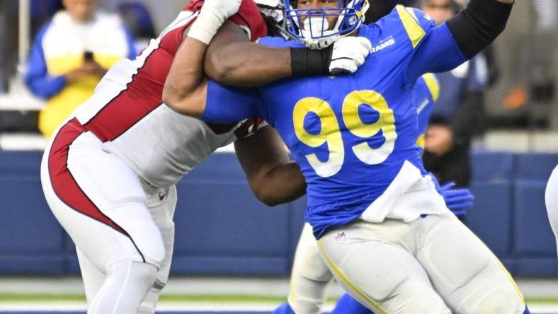 Nov 13, 2022; Inglewood, California, USA; Los Angeles Rams defensive tackle Aaron Donald (99) tries to slip past Arizona Cardinals guard Lecitus Smith (54) to get to quarterback Colt McCoy (not pictured) during the second quarter at SoFi Stadium. Mandatory Credit: Robert Hanashiro-USA TODAY Sports