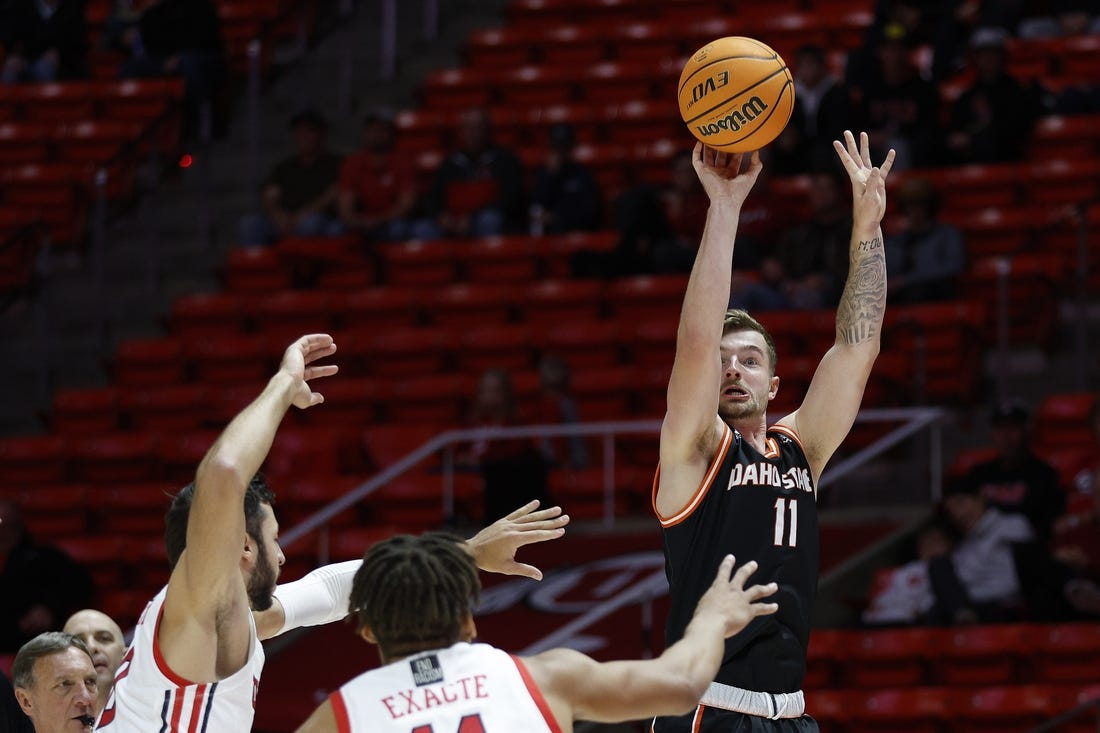 Nov 14, 2022; Salt Lake City, Utah, USA; Idaho State Bengals guard Brock Mackenzie (11) shoots over Utah Utes guard Wilguens Jr. Exacte (11) in the first half at Jon M. Huntsman Center. Mandatory Credit: Jeffrey Swinger-USA TODAY Sports