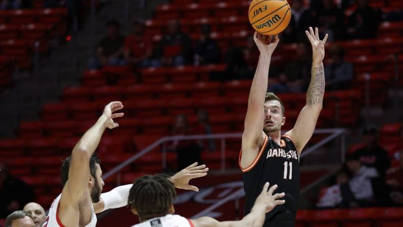 Nov 14, 2022; Salt Lake City, Utah, USA; Idaho State Bengals guard Brock Mackenzie (11) shoots over Utah Utes guard Wilguens Jr. Exacte (11) in the first half at Jon M. Huntsman Center. Mandatory Credit: Jeffrey Swinger-USA TODAY Sports