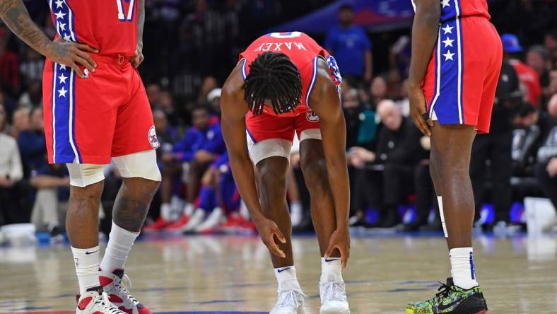 Nov 18, 2022; Philadelphia, Pennsylvania, USA; Philadelphia 76ers guard Tyrese Maxey (0) reaches for his ankle he hurt against the Milwaukee Bucks during the second quarter at Wells Fargo Center. Mandatory Credit: Eric Hartline-USA TODAY Sports