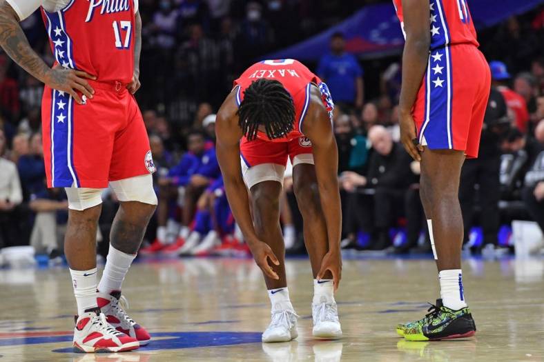 Nov 18, 2022; Philadelphia, Pennsylvania, USA; Philadelphia 76ers guard Tyrese Maxey (0) reaches for his ankle he hurt against the Milwaukee Bucks during the second quarter at Wells Fargo Center. Mandatory Credit: Eric Hartline-USA TODAY Sports