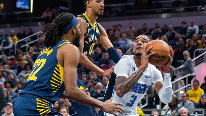 Nov 19, 2022; Indianapolis, Indiana, USA; Orlando Magic forward Chuma Okeke (3) shoots the ball against Indiana Pacers guard Tyrese Haliburton (0) and forward Isaiah Jackson (22) in the first quarter at Gainbridge Fieldhouse. Mandatory Credit: Trevor Ruszkowski-USA TODAY Sports