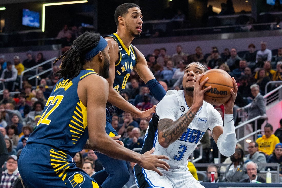 Nov 19, 2022; Indianapolis, Indiana, USA; Orlando Magic forward Chuma Okeke (3) shoots the ball against Indiana Pacers guard Tyrese Haliburton (0) and forward Isaiah Jackson (22) in the first quarter at Gainbridge Fieldhouse. Mandatory Credit: Trevor Ruszkowski-USA TODAY Sports