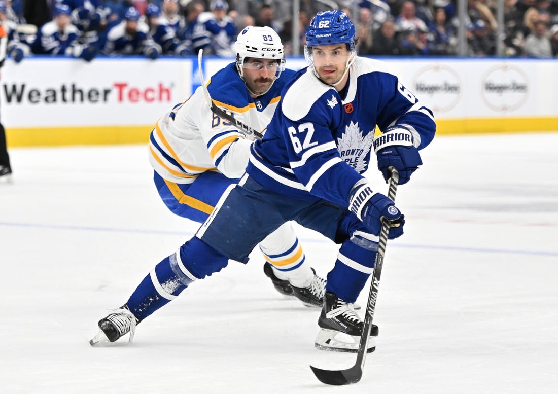 Nov 19, 2022; Toronto, Ontario, CAN;   Toronto Maple Leafs forward Denis Malgin (62) skates the puck away from Buffalo Sabres forward Alex Tuch (89) in the first period at Scotiabank Arena. Mandatory Credit: Dan Hamilton-USA TODAY Sports