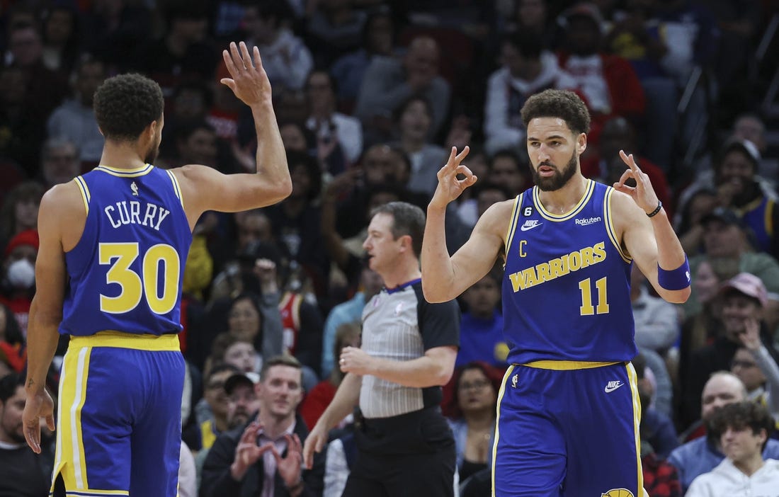 Nov 20, 2022; Houston, Texas, USA; Golden State Warriors guard Klay Thompson (11) and guard Stephen Curry (30) celebrate after a play during the first quarter against the Houston Rockets at Toyota Center. Mandatory Credit: Troy Taormina-USA TODAY Sports