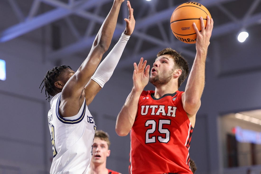 Nov 21, 2022; Fort Myers, Florida, USA;  Utah Utes guard Rollie Worster (25) drives tot the basket  defended by Georgia Tech Yellow Jackets guard Miles Kelly (13) in the first half during the Fort Myers Tip-off at Suncoast Credit Union Arena. Mandatory Credit: Nathan Ray Seebeck-USA TODAY Sports