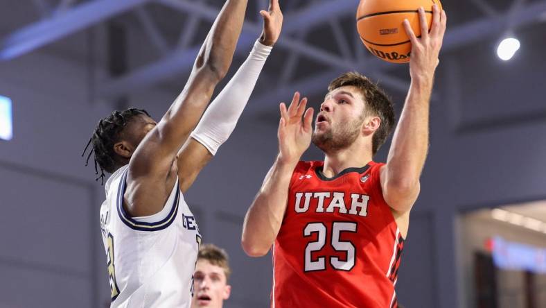 Nov 21, 2022; Fort Myers, Florida, USA;  Utah Utes guard Rollie Worster (25) drives tot the basket  defended by Georgia Tech Yellow Jackets guard Miles Kelly (13) in the first half during the Fort Myers Tip-off at Suncoast Credit Union Arena. Mandatory Credit: Nathan Ray Seebeck-USA TODAY Sports