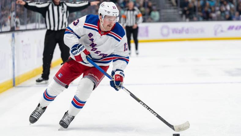 Nov 17, 2022; Seattle, Washington, USA; New York Rangers forward Alexis Lafreniere (13) skates with the puck against the Seattle Kraken at Climate Pledge Arena. Mandatory Credit: Stephen Brashear-USA TODAY Sports