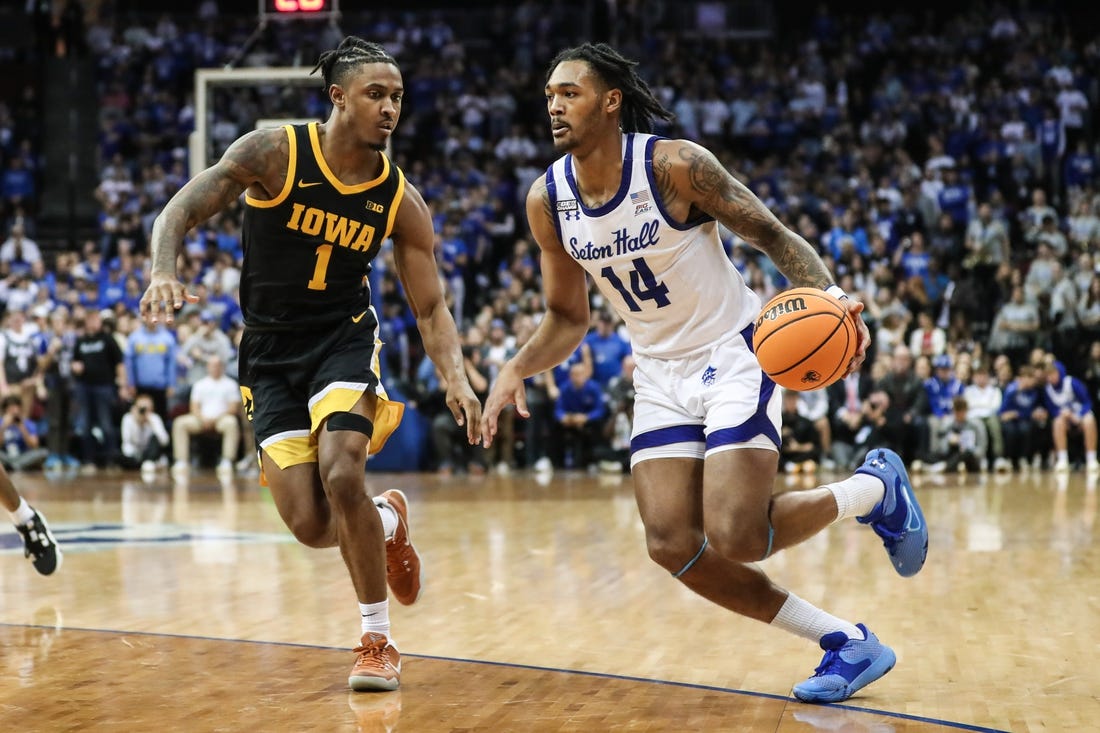 Nov 16, 2022; Newark, New Jersey, USA;  Seton Hall Pirates guard Dre Davis (14) and Iowa Hawkeyes guard Ahron Ulis (1) at Prudential Center. Mandatory Credit: Wendell Cruz-USA TODAY Sports