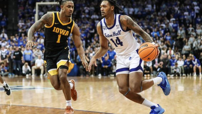 Nov 16, 2022; Newark, New Jersey, USA;  Seton Hall Pirates guard Dre Davis (14) and Iowa Hawkeyes guard Ahron Ulis (1) at Prudential Center. Mandatory Credit: Wendell Cruz-USA TODAY Sports