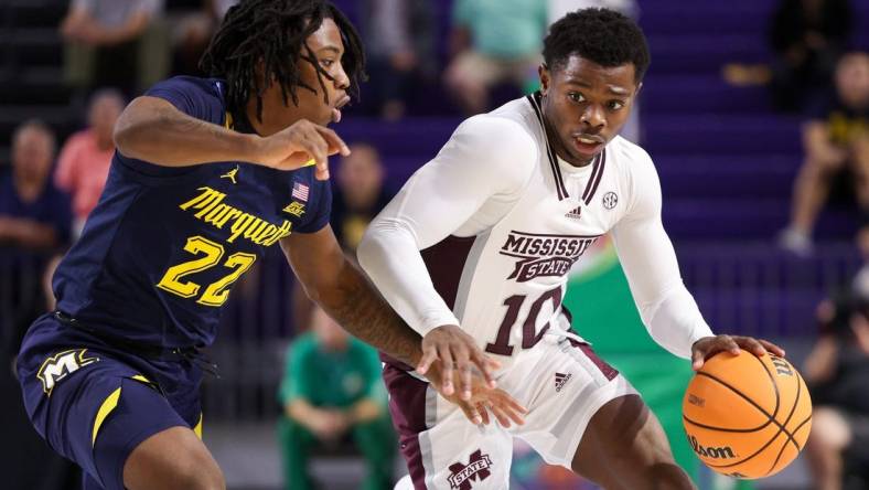 Nov 21, 2022; Fort Myers, Florida, USA;  Mississippi State Bulldogs guard Dashawn Davis (10) cripples past Marquette Golden Eagles guard Sean Jones (22) in the second half during the Fort Myers Tip-off at Suncoast Credit Union Arena. Mandatory Credit: Nathan Ray Seebeck-USA TODAY Sports