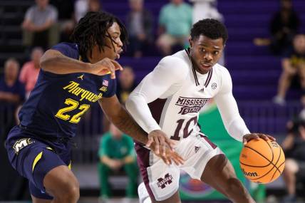 Nov 21, 2022; Fort Myers, Florida, USA;  Mississippi State Bulldogs guard Dashawn Davis (10) cripples past Marquette Golden Eagles guard Sean Jones (22) in the second half during the Fort Myers Tip-off at Suncoast Credit Union Arena. Mandatory Credit: Nathan Ray Seebeck-USA TODAY Sports