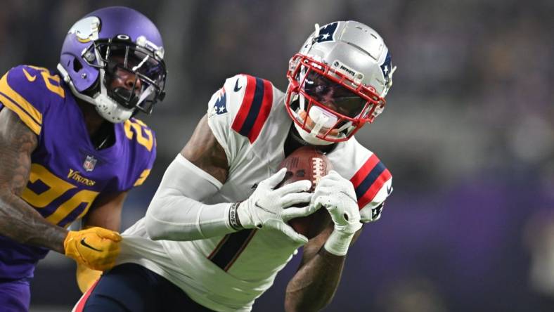 Nov 24, 2022; Minneapolis, Minnesota, USA; New England Patriots wide receiver DeVante Parker (1) catches a pass as Minnesota Vikings cornerback Duke Shelley (20) defends during the third quarter at U.S. Bank Stadium. Mandatory Credit: Jeffrey Becker-USA TODAY Sports