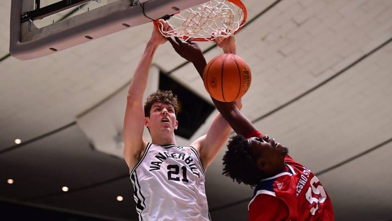 Nov 24, 2022; Anaheim, California, USA; Vanderbilt Commodores forward Liam Robbins (21) dunks for the basket against Fresno State Bulldogs center Eduardo Andre (35) during the second half at Anaheim Convention Center. Mandatory Credit: Gary A. Vasquez-USA TODAY Sports