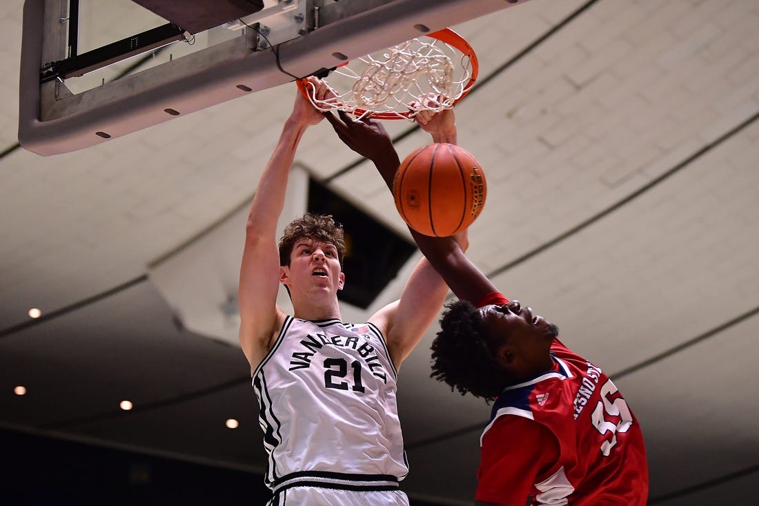 Nov 24, 2022; Anaheim, California, USA; Vanderbilt Commodores forward Liam Robbins (21) dunks for the basket against Fresno State Bulldogs center Eduardo Andre (35) during the second half at Anaheim Convention Center. Mandatory Credit: Gary A. Vasquez-USA TODAY Sports