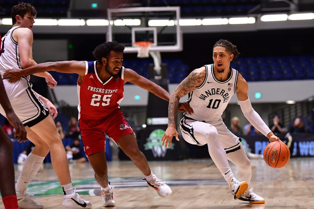 Nov 24, 2022; Anaheim, California, USA; Vanderbilt Commodores forward Myles Stute (10) moves the ball as forward Liam Robbins (21) provides coverage against Fresno State Bulldogs guard Anthony Holland (25) during the second half at Anaheim Convention Center. Mandatory Credit: Gary A. Vasquez-USA TODAY Sports