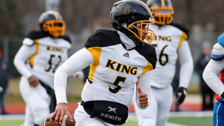 Detroit King quarterback Dante Moore (5) runs against Mason during the second half of Division 3 state semifinal at John Glenn High School in Westland on Saturday, Nov. 19, 2022.