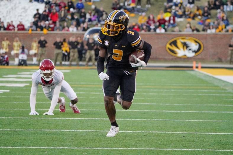 Nov 25, 2022; Columbia, Missouri, USA; Missouri Tigers wide receiver Dominic Lovett (7) runs in for a touchdown against Arkansas Razorbacks during the second half at Faurot Field at Memorial Stadium. Mandatory Credit: Denny Medley-USA TODAY Sports