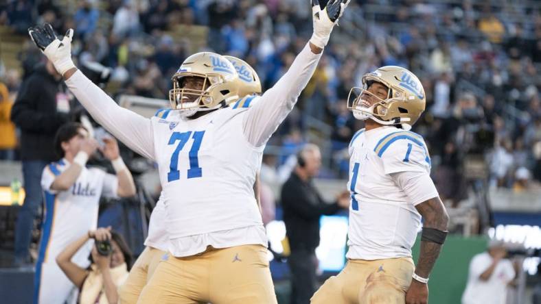 November 25, 2022; Berkeley, California, USA; UCLA Bruins offensive lineman Raiqwon O'Neal (71) and quarterback Dorian Thompson-Robinson (1) celebrate a two-point conversion against the California Golden Bears during the fourth quarter at California Memorial Stadium. Mandatory Credit: Kyle Terada-USA TODAY Sports