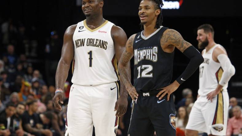 Nov 25, 2022; Memphis, Tennessee, USA; New Orleans Pelicans forward Zion Williamson (1) and Memphis Grizzlies guard Ja Morant (12) talk during free throws during the second half at FedExForum. Mandatory Credit: Petre Thomas-USA TODAY Sports