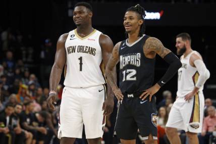 Nov 25, 2022; Memphis, Tennessee, USA; New Orleans Pelicans forward Zion Williamson (1) and Memphis Grizzlies guard Ja Morant (12) talk during free throws during the second half at FedExForum. Mandatory Credit: Petre Thomas-USA TODAY Sports