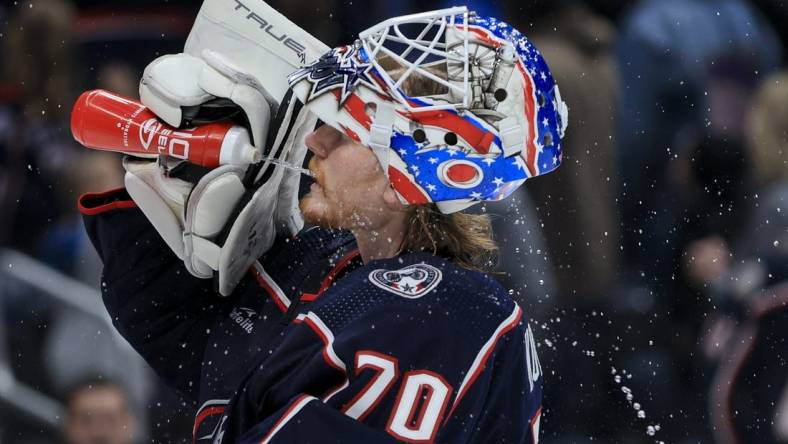 Nov 25, 2022; Columbus, Ohio, USA;  Columbus Blue Jackets goaltender Joonas Korpisalo (70) sprays his face with water during a stop in play against the the New York Islanders in the third period at Nationwide Arena. Mandatory Credit: Aaron Doster-USA TODAY Sports