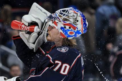 Nov 25, 2022; Columbus, Ohio, USA;  Columbus Blue Jackets goaltender Joonas Korpisalo (70) sprays his face with water during a stop in play against the the New York Islanders in the third period at Nationwide Arena. Mandatory Credit: Aaron Doster-USA TODAY Sports