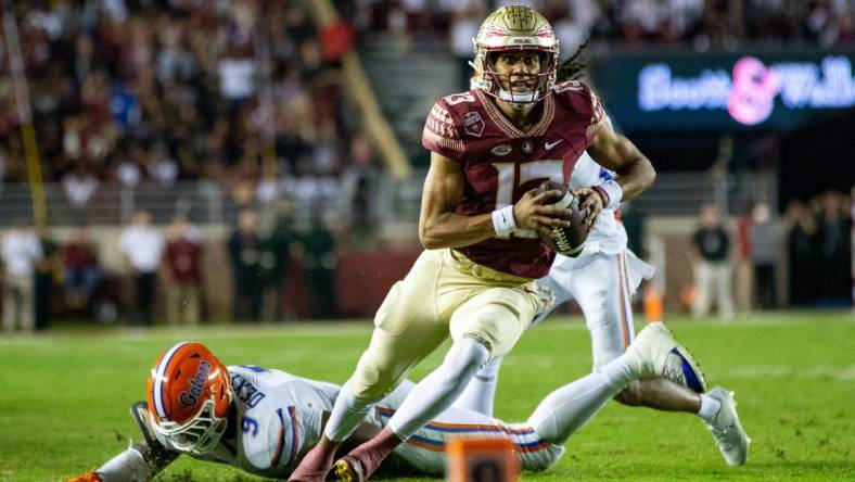 Florida State Seminoles quarterback Jordan Travis (13) eyes the end zone as he runs down the field. The Florida State Seminoles defeated the Florida Gators 45-38 at Doak Campbell Stadium on Friday, Nov. 25, 2022.

Fsu V Uf First Half1485