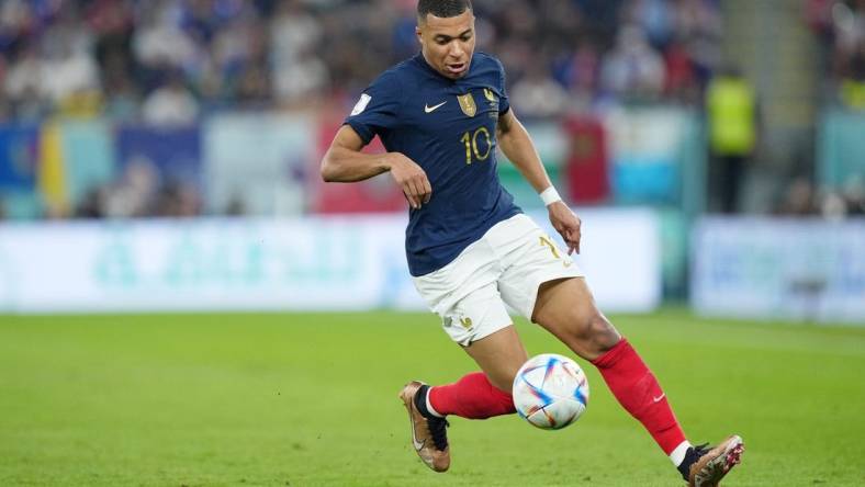 Nov 26, 2022; Doha, Qatar; France forward Kylian Mbappe (10) controls the ball against Denmark during the first half of a group stage match during the 2022 World Cup at Stadium 974. Mandatory Credit: Danielle Parhizkaran-USA TODAY Sports