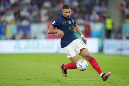 Nov 26, 2022; Doha, Qatar; France forward Kylian Mbappe (10) controls the ball against Denmark during the first half of a group stage match during the 2022 World Cup at Stadium 974. Mandatory Credit: Danielle Parhizkaran-USA TODAY Sports
