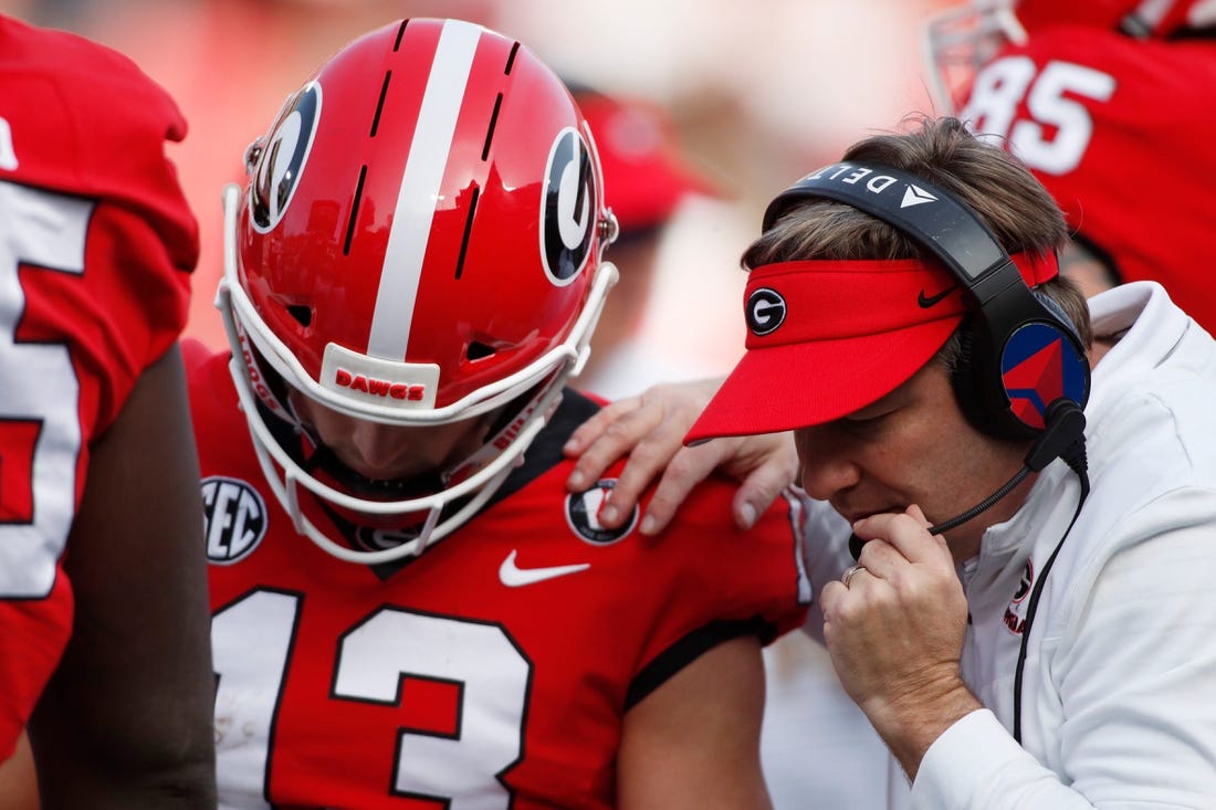 Georgia head coach Kirby Smart speaks with Georgia quarterback Stetson Bennett (13) in the huddle during the second half of an NCAA college football game between Georgia Tech and Georgia in Athens, Ga., on Saturday, Nov. 26, 2022. Georgia won 37-14.

News Joshua L Jones