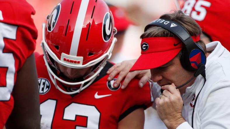 Georgia head coach Kirby Smart speaks with Georgia quarterback Stetson Bennett (13) in the huddle during the second half of an NCAA college football game between Georgia Tech and Georgia in Athens, Ga., on Saturday, Nov. 26, 2022. Georgia won 37-14.

News Joshua L Jones