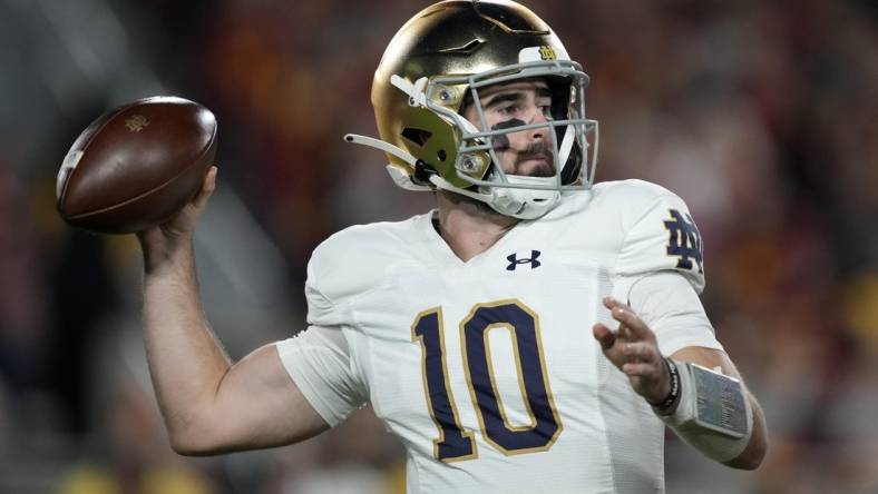 Nov 26, 2022; Los Angeles, California, USA; Notre Dame Fighting Irish quarterback Drew Pyne (10) throws the ball against the Southern California Trojans in the first half at United Airlines Field at Los Angeles Memorial Coliseum. Mandatory Credit: Kirby Lee-USA TODAY Sports