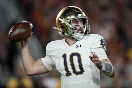 Nov 26, 2022; Los Angeles, California, USA; Notre Dame Fighting Irish quarterback Drew Pyne (10) throws the ball against the Southern California Trojans in the first half at United Airlines Field at Los Angeles Memorial Coliseum. Mandatory Credit: Kirby Lee-USA TODAY Sports