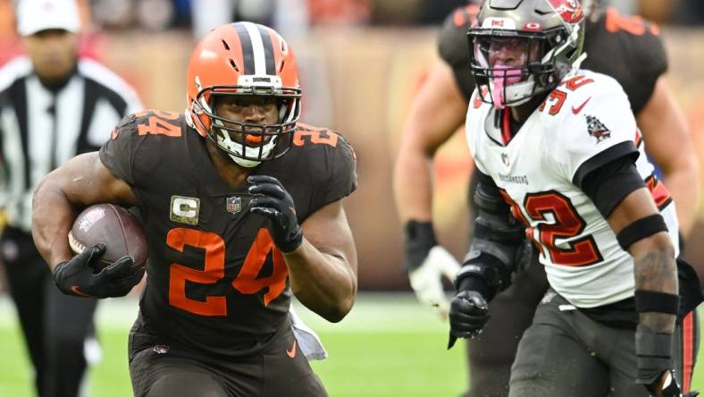 Nov 27, 2022; Cleveland, Ohio, USA; Cleveland Browns running back Nick Chubb (24) runs with the ball as Tampa Bay Buccaneers safety Mike Edwards (32) defends during the first half at FirstEnergy Stadium. Mandatory Credit: Ken Blaze-USA TODAY Sports