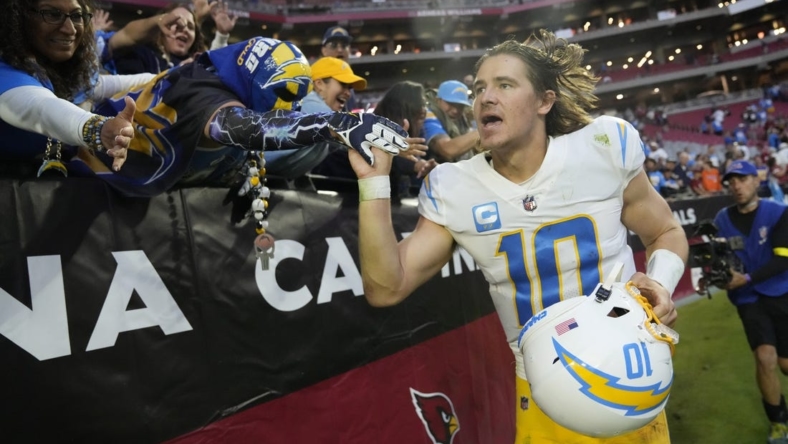Nov 27, 2022; Glendale, AZ, USA;  Los Angeles Chargers quarterback Justin Herbert (10) celebrates with fans after winning 25-24 against the Arizona Cardinals at State Farm Stadium. Mandatory Credit: Michael Chow-USA TODAY Sports