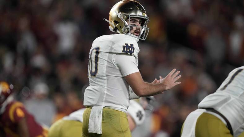 Nov 26, 2022; Los Angeles, California, USA; Notre Dame Fighting Irish quarterback Drew Pyne (10) prepares to take the snap against the Southern California Trojans in the first half at United Airlines Field at Los Angeles Memorial Coliseum. Mandatory Credit: Kirby Lee-USA TODAY Sports