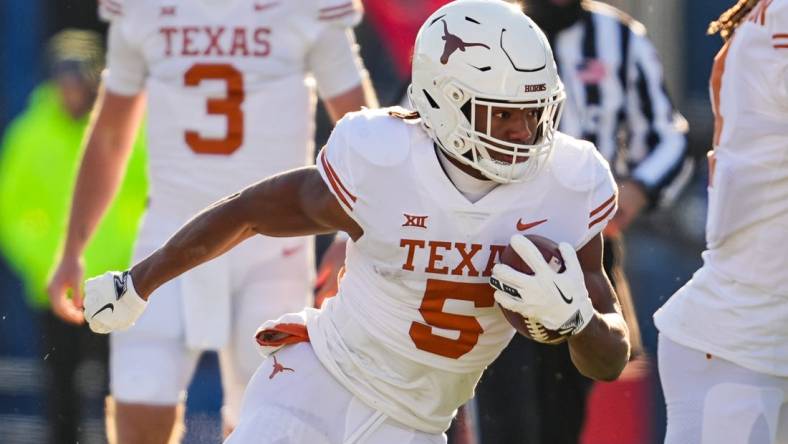 Nov 19, 2022; Lawrence, Kansas, USA; Texas Longhorns running back Bijan Robinson (5) runs the ball during the first half against the Kansas Jayhawks at David Booth Kansas Memorial Stadium. Mandatory Credit: Jay Biggerstaff-USA TODAY Sports