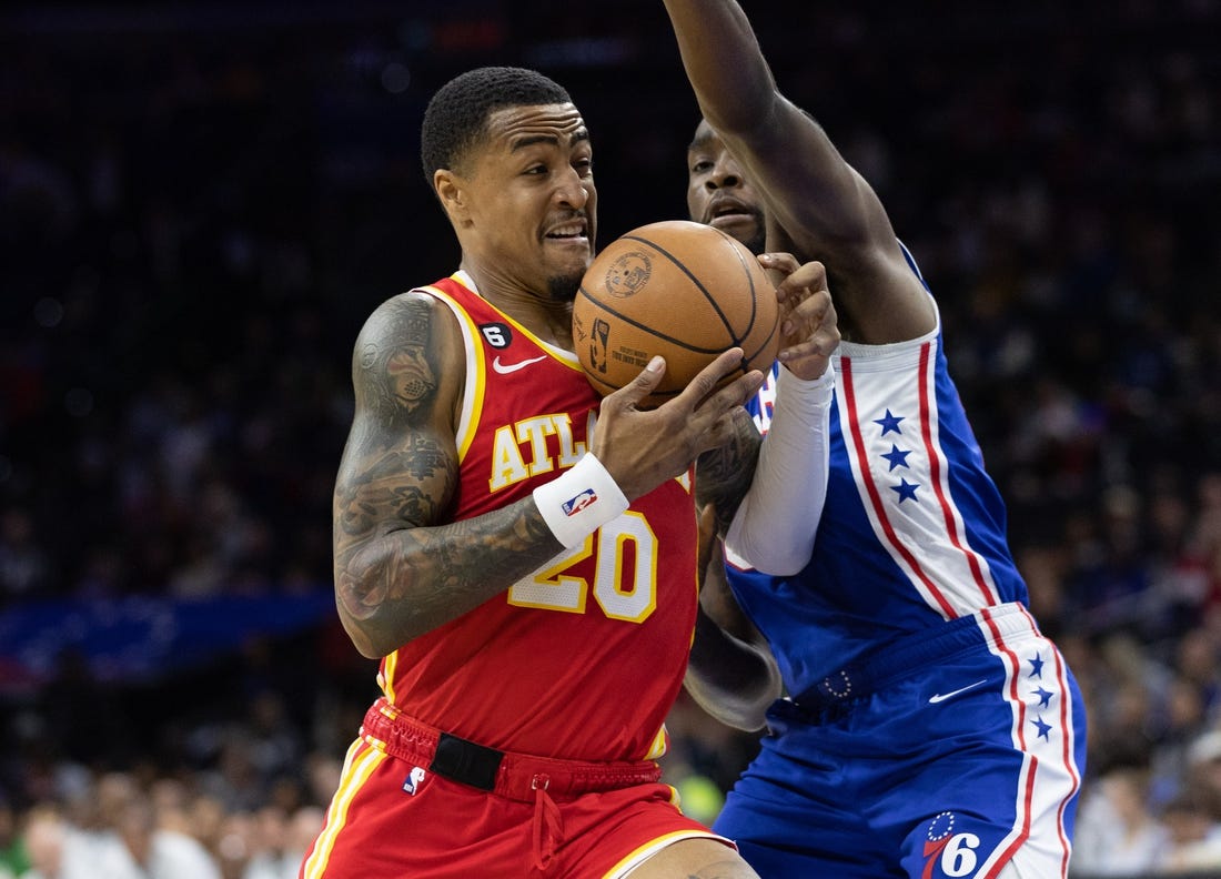 Nov 28, 2022; Philadelphia, Pennsylvania, USA; Atlanta Hawks forward John Collins (20) drives against Philadelphia 76ers guard Shake Milton (18) during the first quarter at Wells Fargo Center. Mandatory Credit: Bill Streicher-USA TODAY Sports