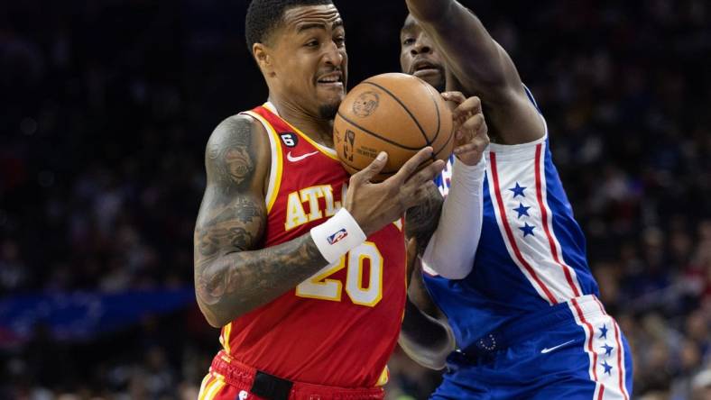 Nov 28, 2022; Philadelphia, Pennsylvania, USA; Atlanta Hawks forward John Collins (20) drives against Philadelphia 76ers guard Shake Milton (18) during the first quarter at Wells Fargo Center. Mandatory Credit: Bill Streicher-USA TODAY Sports