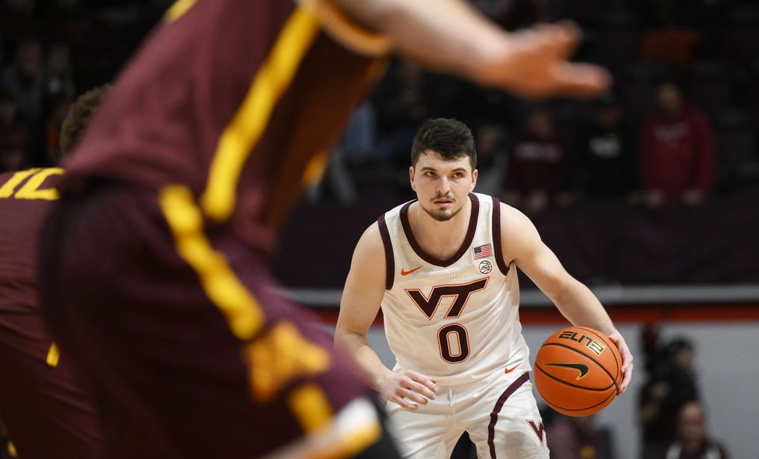 Nov 28, 2022; Blacksburg, Virginia, USA; Virginia Tech Hokies guard Hunter Cattoor (0) dribbles against the Minnesota Golden Gophers defense in the second half at Cassell Coliseum. Mandatory Credit: Lee Luther Jr.-USA TODAY Sports